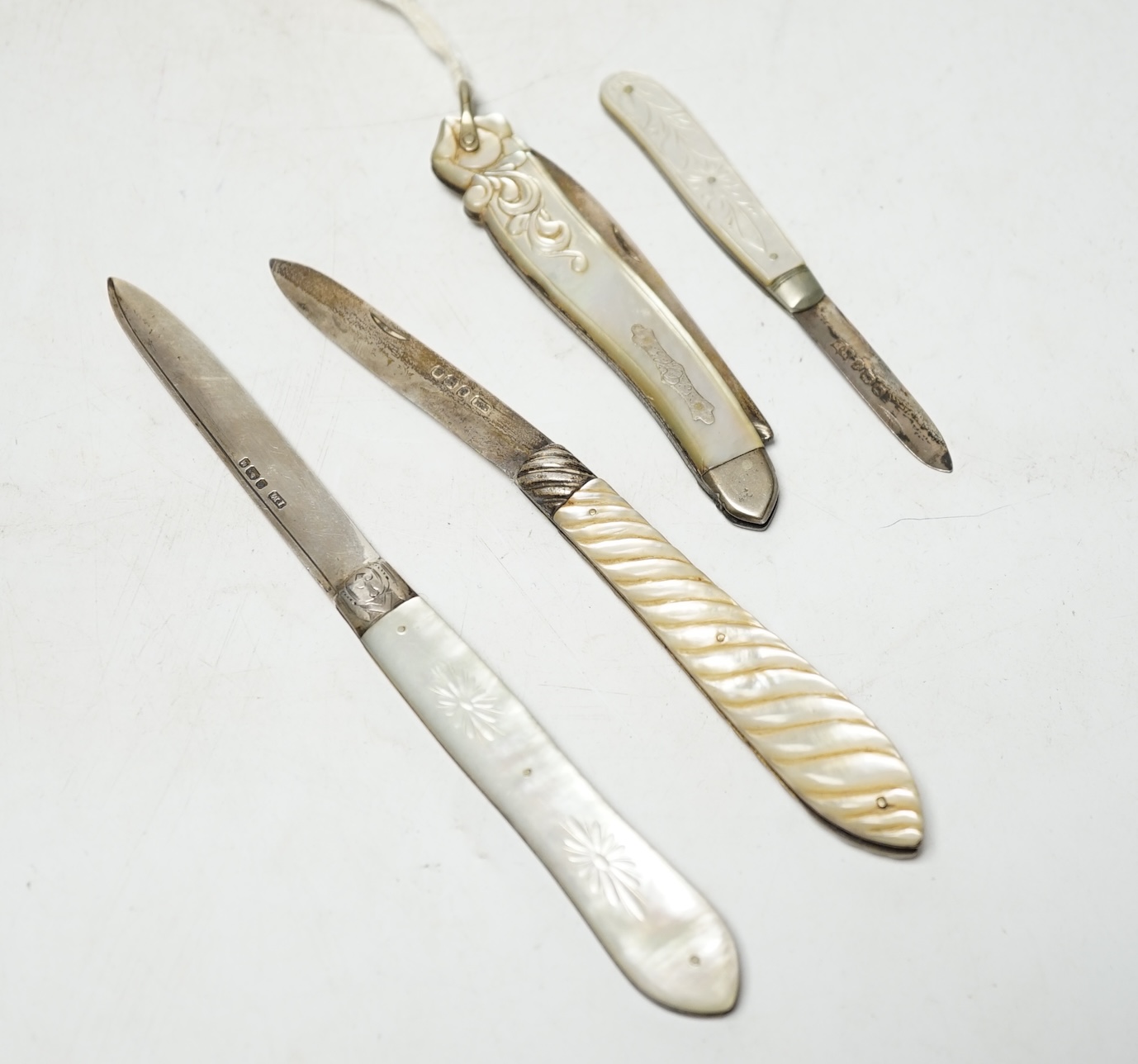 Four assorted Victorian silver and mother of pearl fruit knives, largest Francis Clark, Birmingham, 1843, 90mm. Condition - fair.